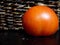 Ripe tomato with brown woven basket