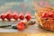 Ripe tomatoes on a wooden table, basket, cutting board