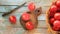 Ripe tomatoes on a wooden table, basket, cutting board