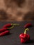 Ripe Trinidad Scorpion Moruga Capsicum Chinense and Red Thai Cayenne Pepper on dark blurred background