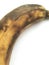 Ripe unpeeled banana lying on a white background. Abstract macro shot.