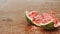 A ripe watermelon falls to the floor and smashes to pieces. Sprays fly in all directions. Slow motion 180 fps video