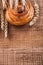 Ripe wheat ears rich raisin bun on oaken wooden