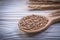 Ripe wheat and rye ears wooden spoon corn crop on wood board