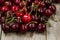 Ripe whole black cherries on rustic wood ready to eat