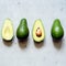 Ripe whole green avocado on a gray background. Flat lay. Food concept. Top view. Green avocadoes pattern