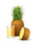 Ripe whole and sliced pineapple with glass ofjuice