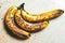 Ripe yellow bananas fruits, bunch of ripe bananas with dark spots on a white background with clipping path