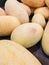 Ripe yellow melons torpedo lie on the counter of the store