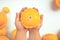 Ripe, yellow patisson in children& x27;s hands on the background of a large number of vegetables on a white background.