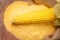 Ripe young sweet corn cob and cornmeal close up