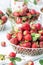 Ripen fresh strawberries in white braided metal container on white background, fresh homegrown berries served to eat