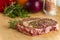 Ripened seasoned beef rib eye or entrecote steak on wooden cut board prepared for cooking