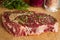 Ripened seasoned beef rib eye or entrecote steak on wooden cut board prepared for cooking