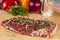 Ripened seasoned beef rump or striploin steak on wooden cut board prepared for cooking
