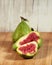 Ripening figs on wooden background, one fruit - cutting