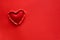 Ripped paper hole heart shaped with felt heart on red paper background. Valentine`s day celebration concept