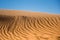 Ripple sand dunes and blue sky background