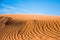 Ripple sand dunes and blue sky background