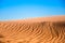 Ripple sand dunes and blue sky background