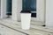 Ripple white paper cup of coffee to takeaway at the wooden floor terrace outside.