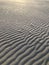 Rippled sand dunes in early morning light on Grado beach - Italy