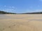 Rippled sand and meandering tide pools on the Bushmans River at low tide.