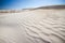 Rippled white sand dunes with coloured minerals