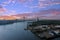 The rippling blue waters of the Savannah River with the Talmadge Memorial Bridge over the water and hotels, office buildings