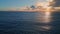 Rippling ocean surface reflecting beautiful sunset. Aerial view marine sunrise