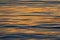 Rippling water with sunset colours reflecting background