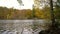 Rippling water on a tranquil lake surrounded by trees in Autumn or Fall