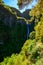 Risco Waterfall - Hiking on Levada trail 25 Fontes in Laurel forest at Rabacal - beautiful landscape scenery - Madeira Island,