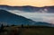 The rise of a cloud in mountains at dawn