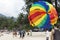 On the rise in the sky large parachute in the blue sky tropical beach. Two Chinese tourists flying on a parachute over the sea on