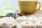 Risen doughnut dough on flowered wood table with cutter and rolli