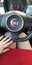 Rishon lezion, Israel - february 28, 2019: woman in red mini dress on drivers seat in fiat 500 salon holds her hand on