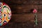Rishtan Uzbek national plate and pink spring flower on wooden background