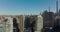 Rising footage of tall buildings, revealing view of various buildings in city and autumn foliage in park. Manhattan, New