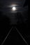 Rising full moon over a single railway-line