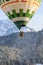 rising hot air balloon in cloaseup flying and floating over the Swiss Alps