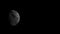 Rising moon, black and white, appearing from behind cloud. .