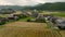 Rising over traditional Japanese homes by wheat and rice fields in countryside