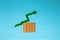 rising raw material prices, creative design, wood and green arrow up, on a blue background