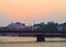 Rising Sun above City with Orange Sky and Bridge over Holy River Ganges - Ganga - Har ki Paudi, Haridwar, Uttarakhand, India