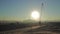 He rising sun appears from behind a silhouette building of the construction site - Time Lapse -