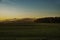 Rising sun panorama of meadows and hills
