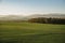 Rising sun panorama of meadows and hills