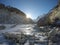 Rising sun in snowy valley