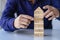 risk management concepts Hands trying to protect the crumbling wooden blocks block tower businessman